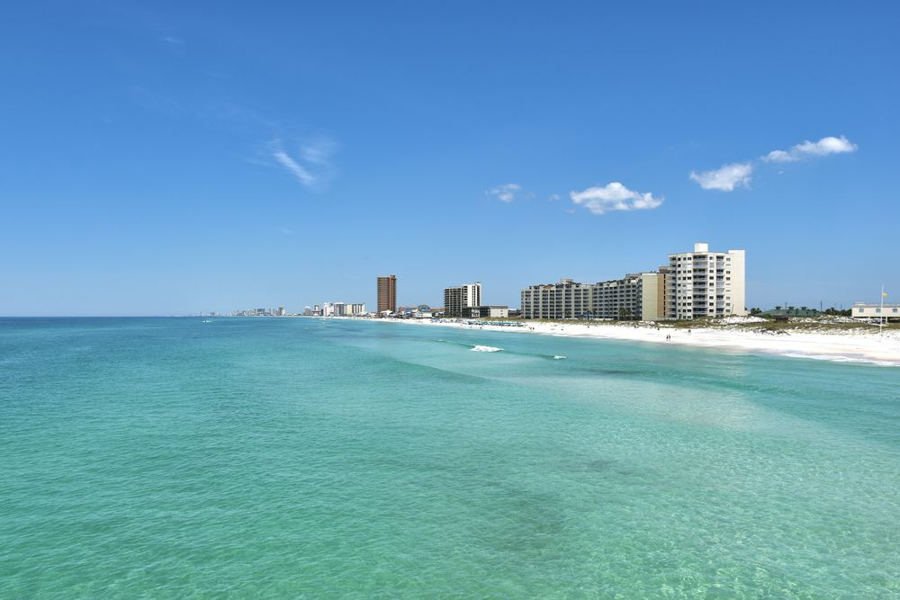 Emerald-green Gulf water along the white-sand shoreline of Panama City Beach